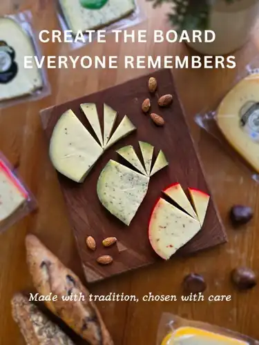 Wedges of local Gouda-style farm cheeses with almonds, chestnuts and fresh bread on a wooden board at Natura Corner
